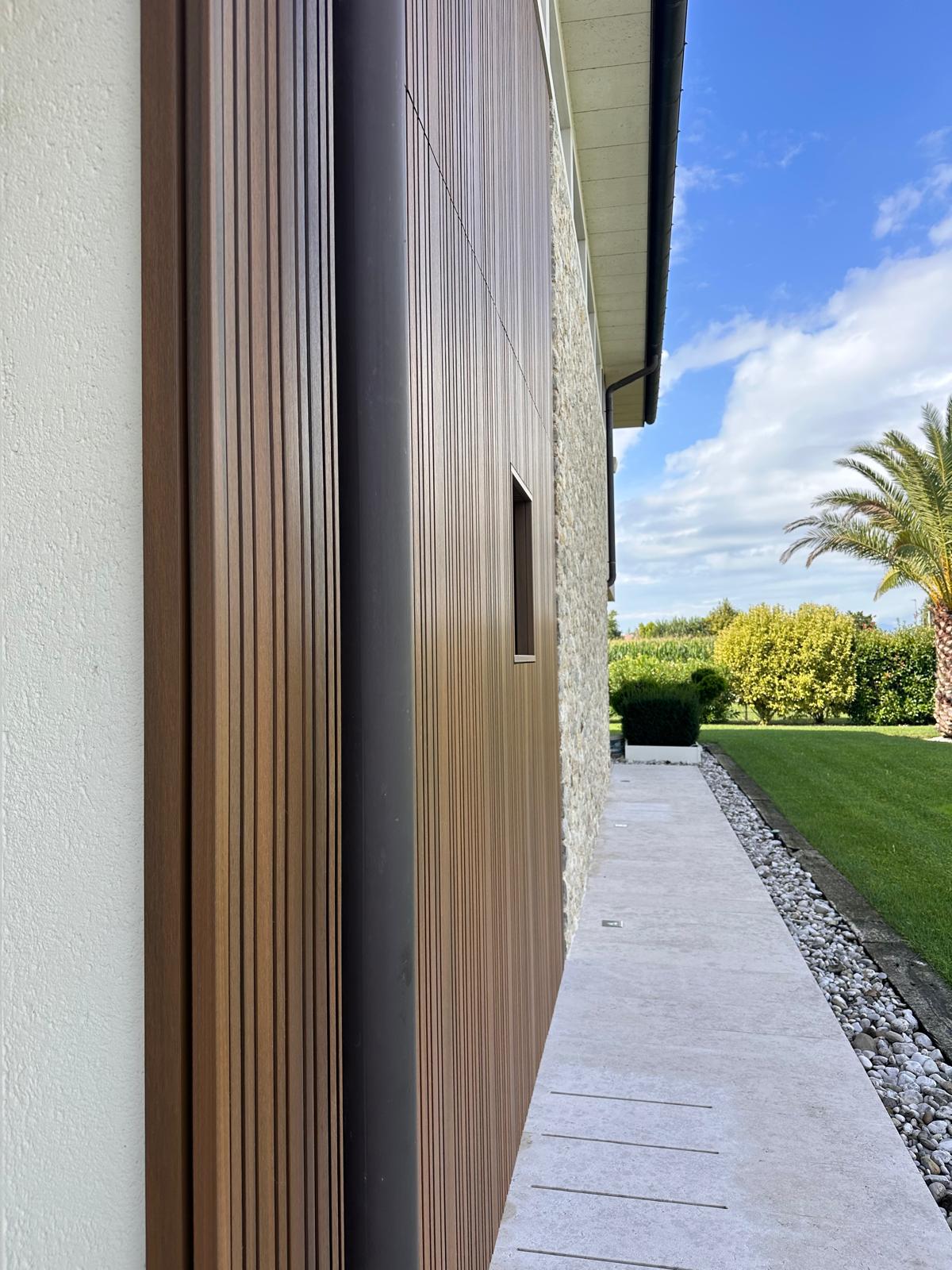 Rivestimento esterno a doghe effetto teak accanto al giardino vicino a Mussolente